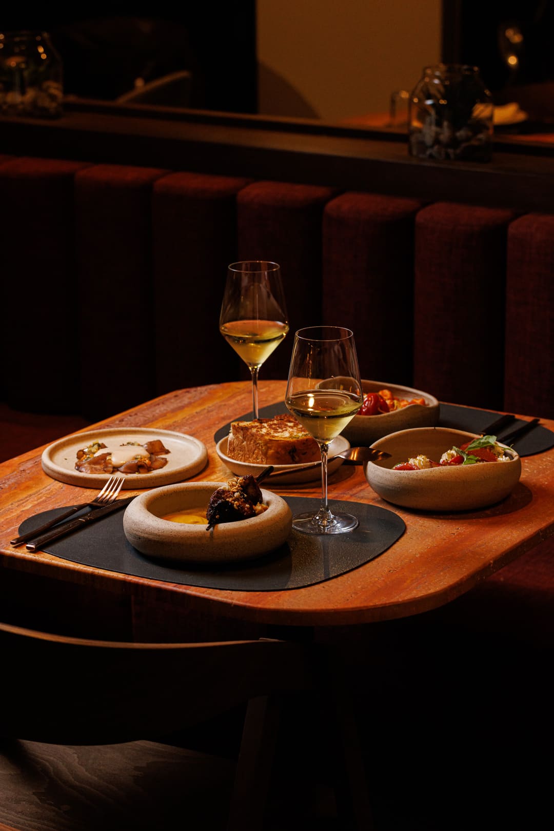 A chef’s table set with a course of small plates