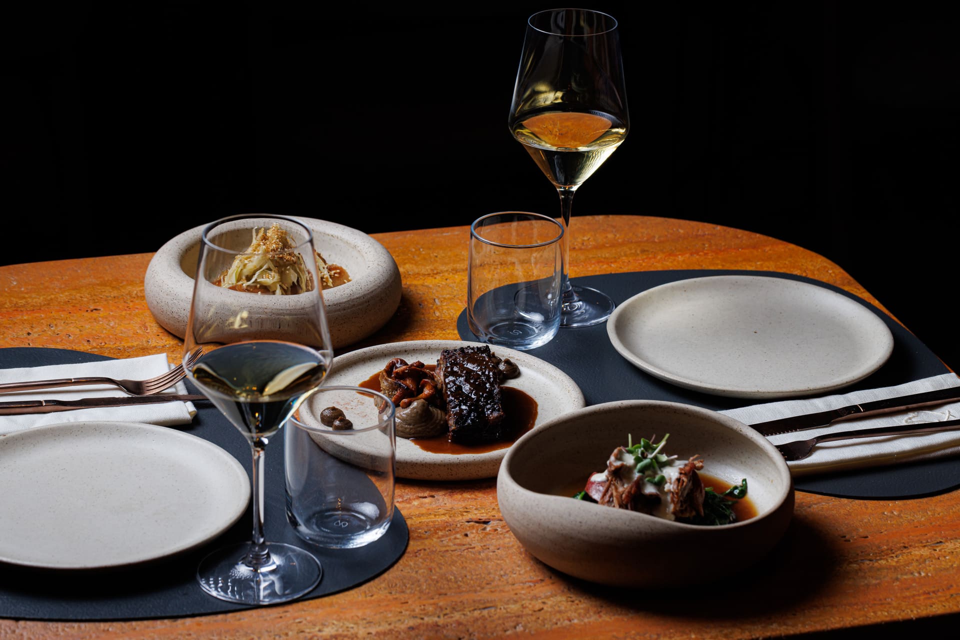 A table laid for the tasting menu with wine poured