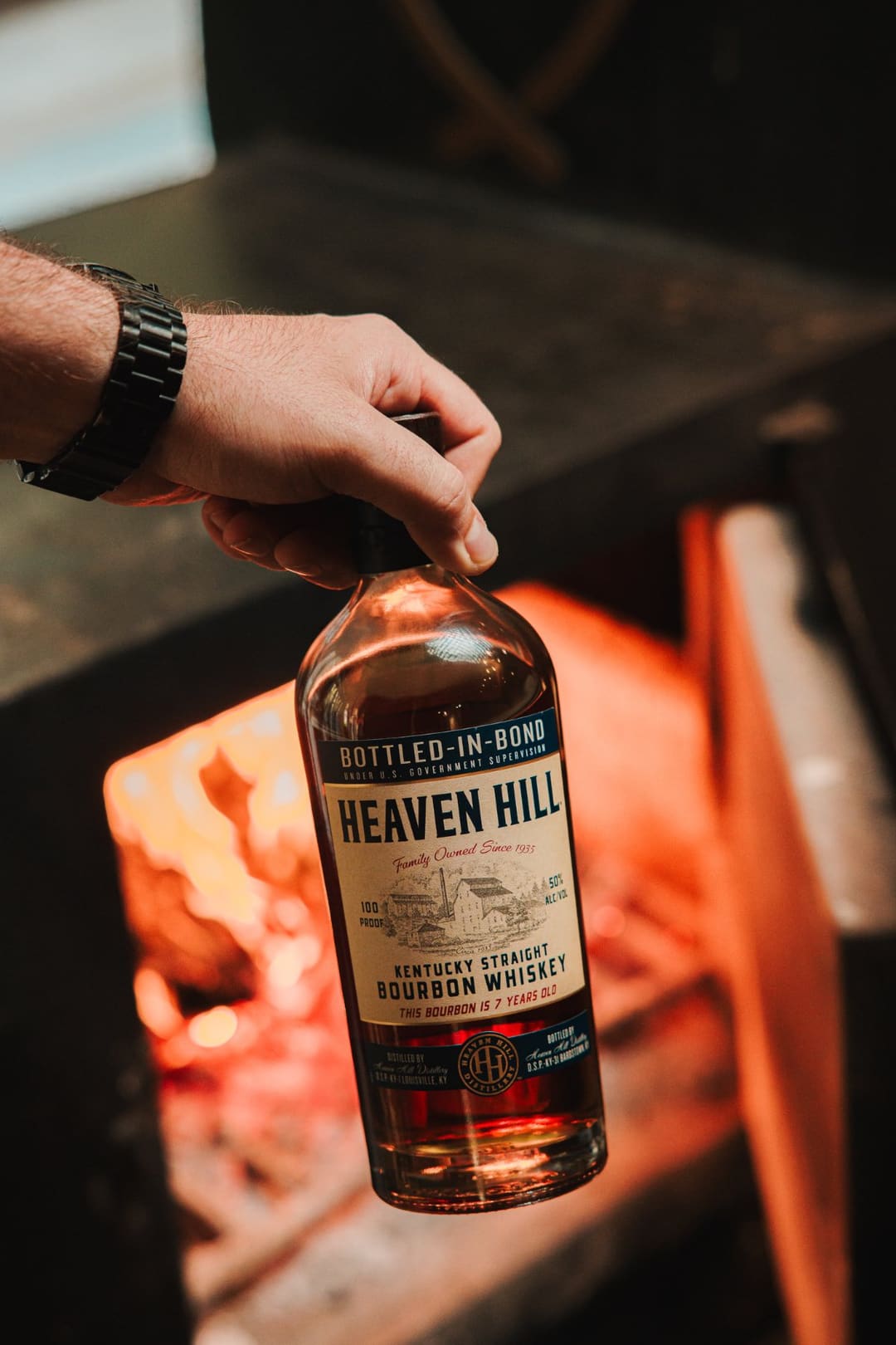 A bottle of Kentucky straight bourbon held beside the fire