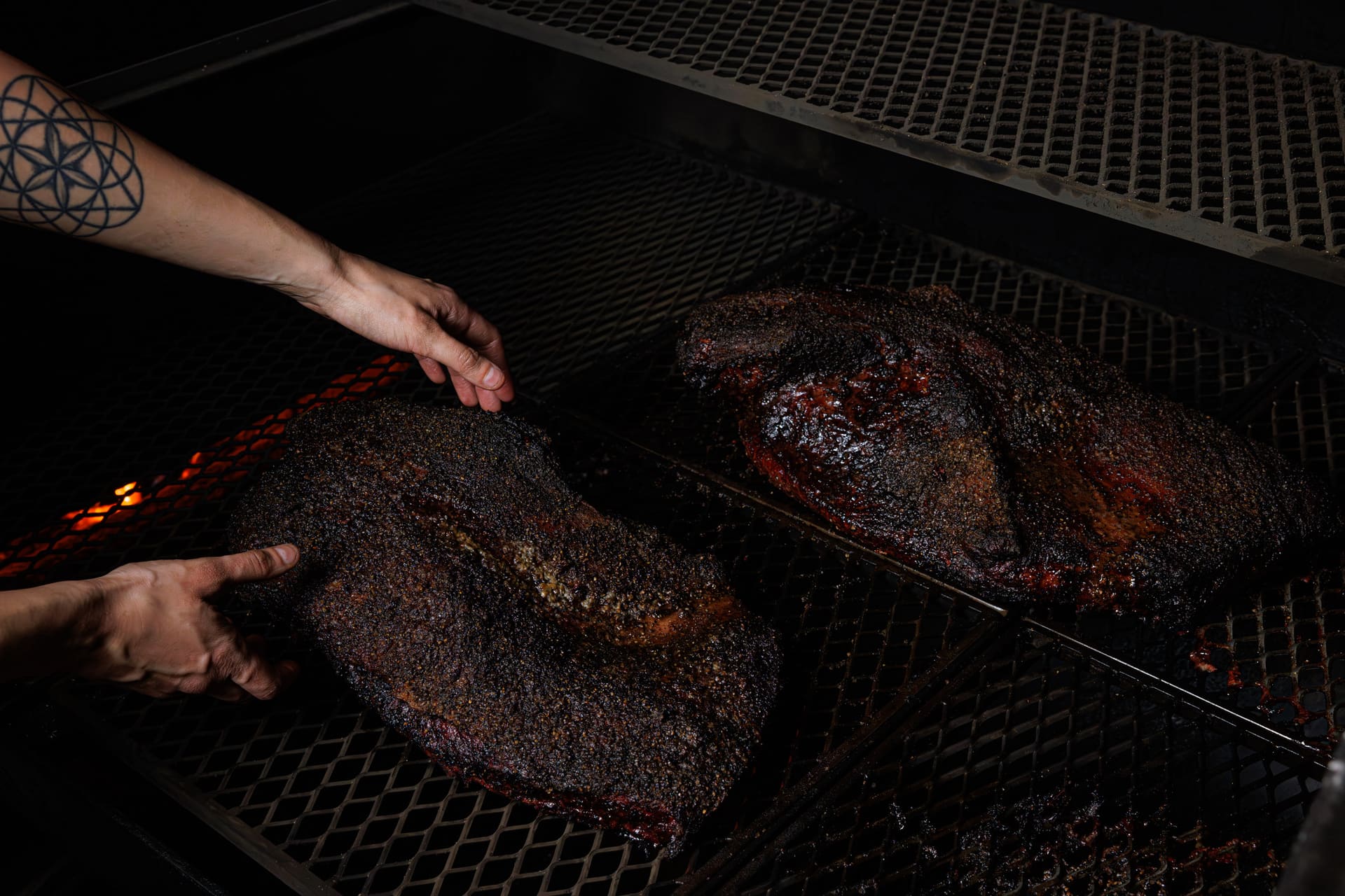 Brisket resting on the grate inside a working smoker